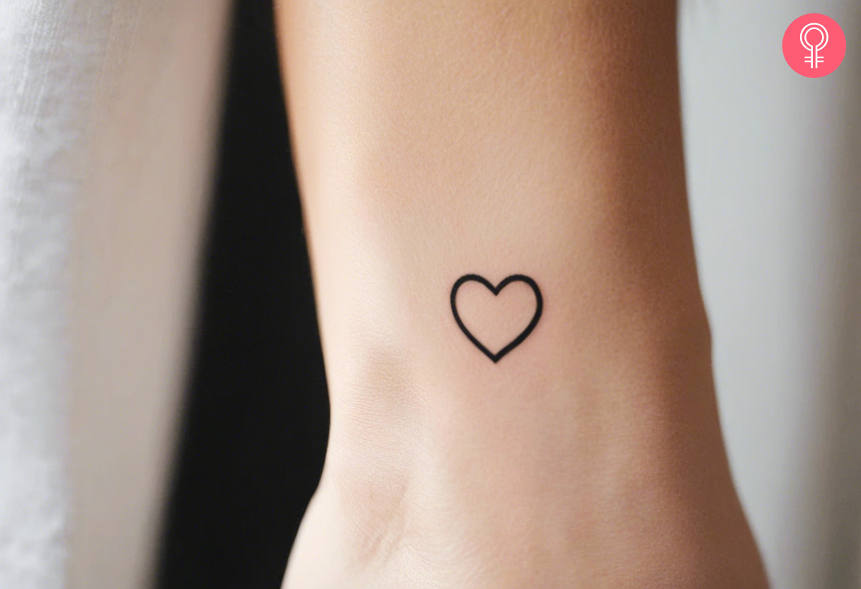 A woman with a simple, small heart tattoo on her wrist