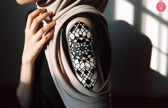 A black and white stained glass mandala tattoo