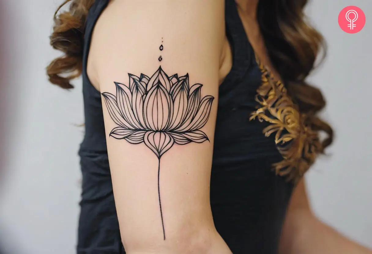 Woman with strength flower tattoo on her outer arm