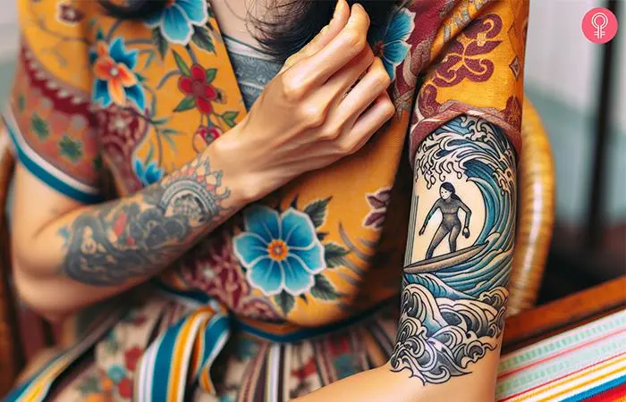 Woman with a surfer girl tattoo on the upper arm