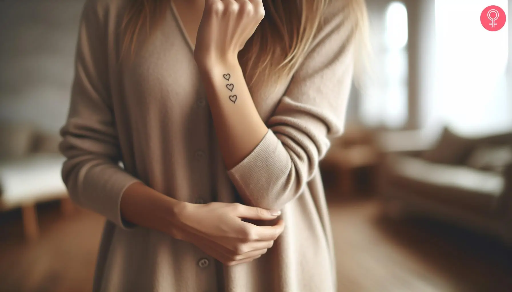 A woman with a three heart tattoo on her wrist