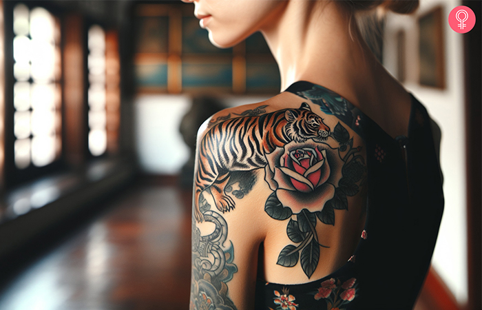 A woman with a colorful tiger rose tattoo on her shoulder