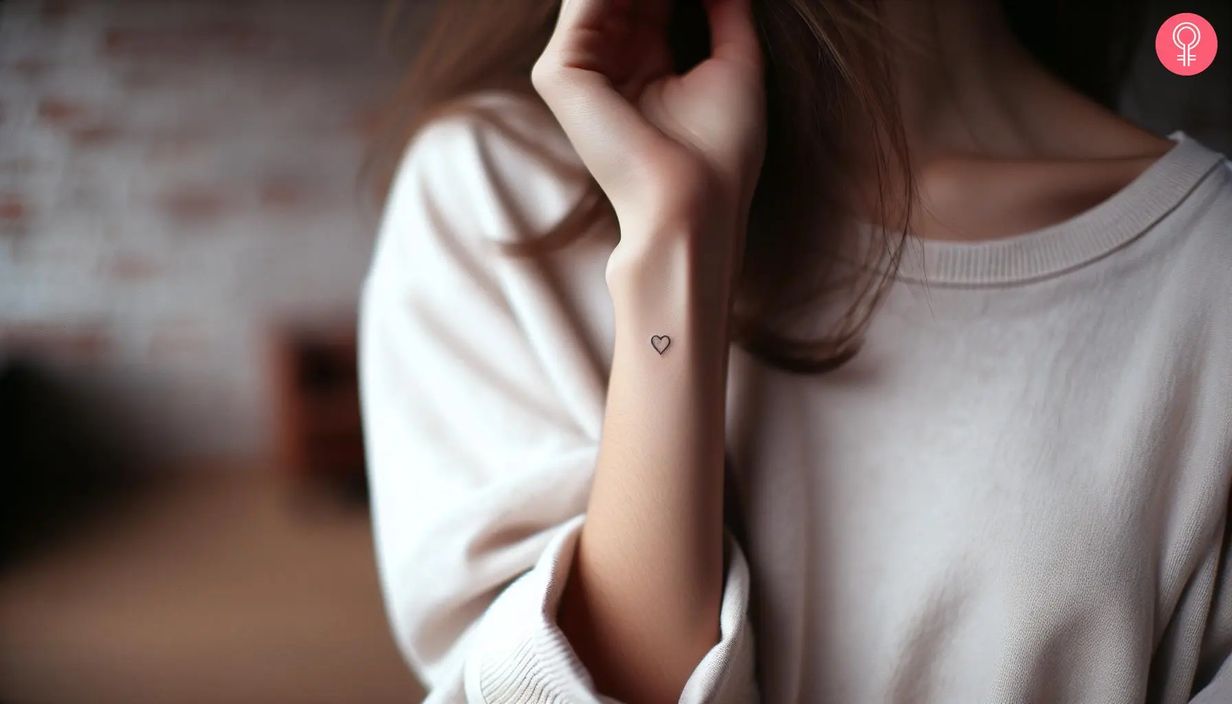 A woman with a tiny heart tattoo on her wrist