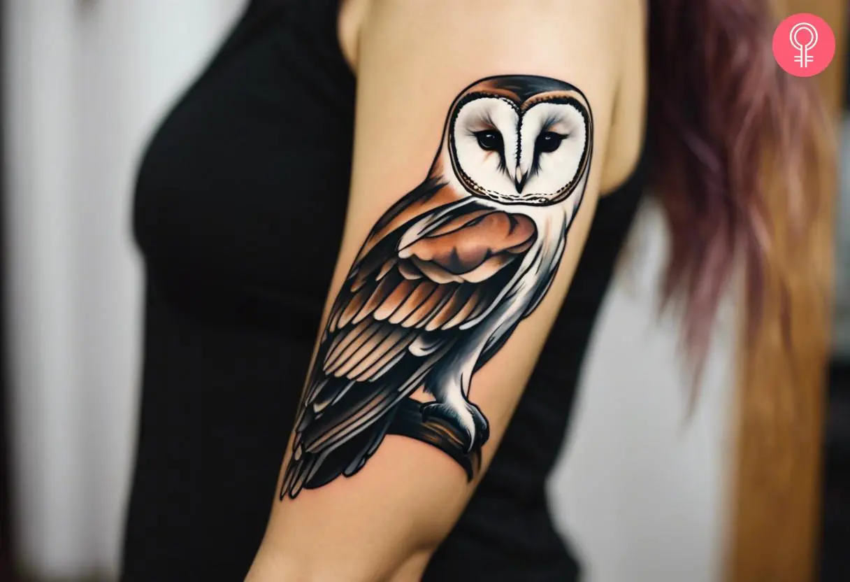 A woman with a colored traditional barn owl tattoo on her upper arm