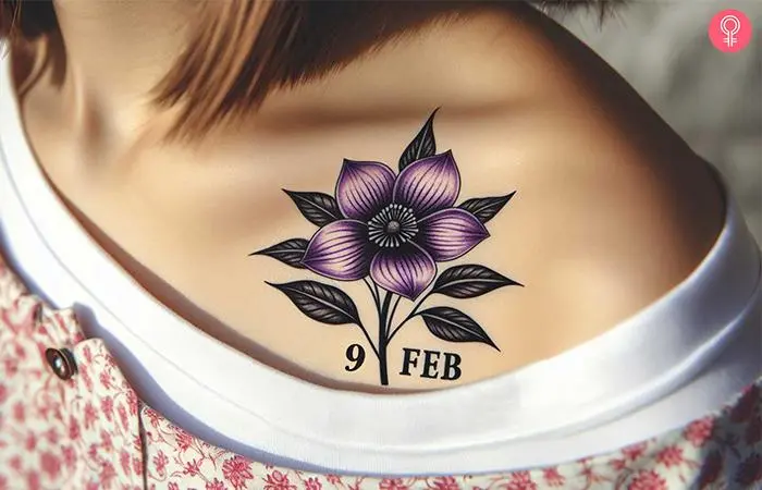 A woman wearing a February birth flower tattoo on her shoulder