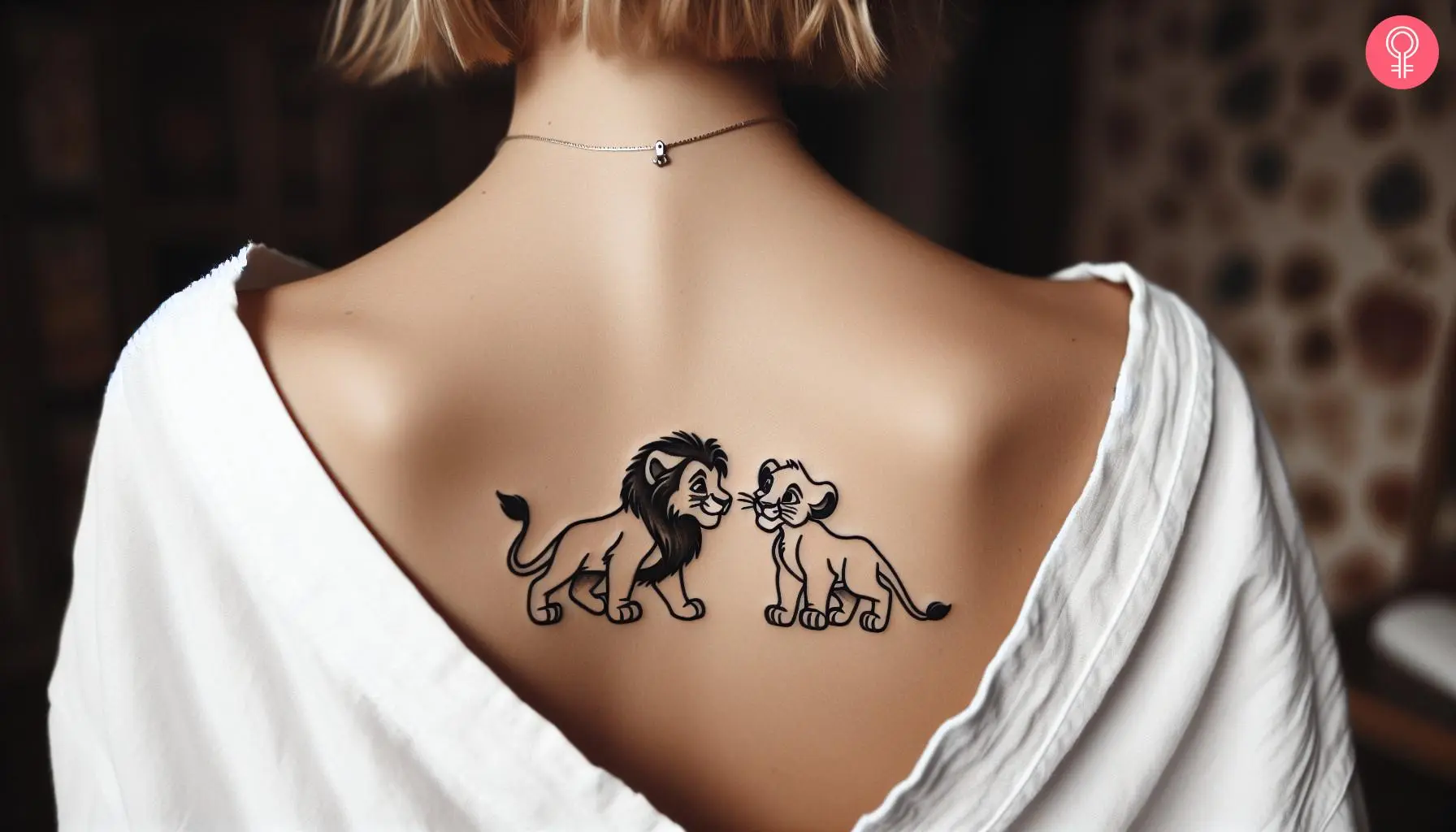 Woman with Nala and Simba tattoo on her upper back