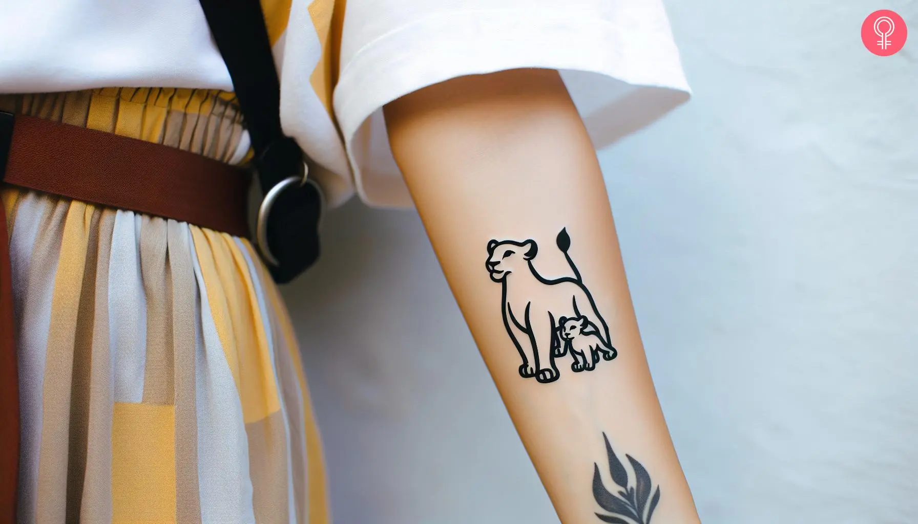 Woman with Sarabi and baby Simba tattoo on her forearm