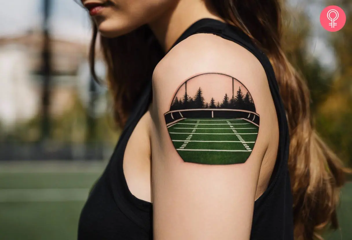 Woman with an American football field tattoo on the upper arm