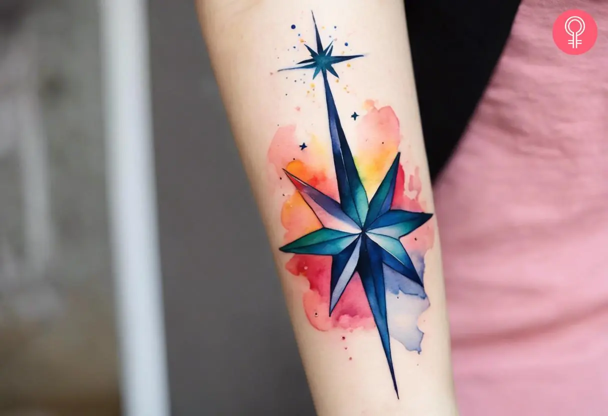 Woman with colorful North Star tattoo on her forearm