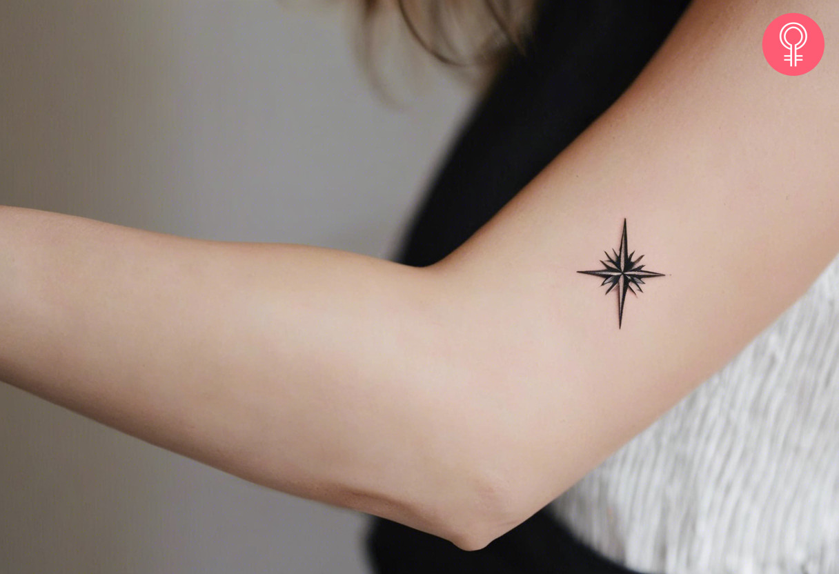 Woman with minimalist North Star tattoo on her arm