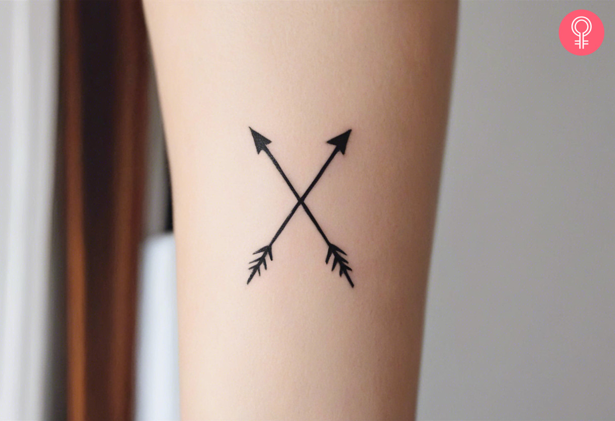  Woman with a X arrow tattoo on the forearm