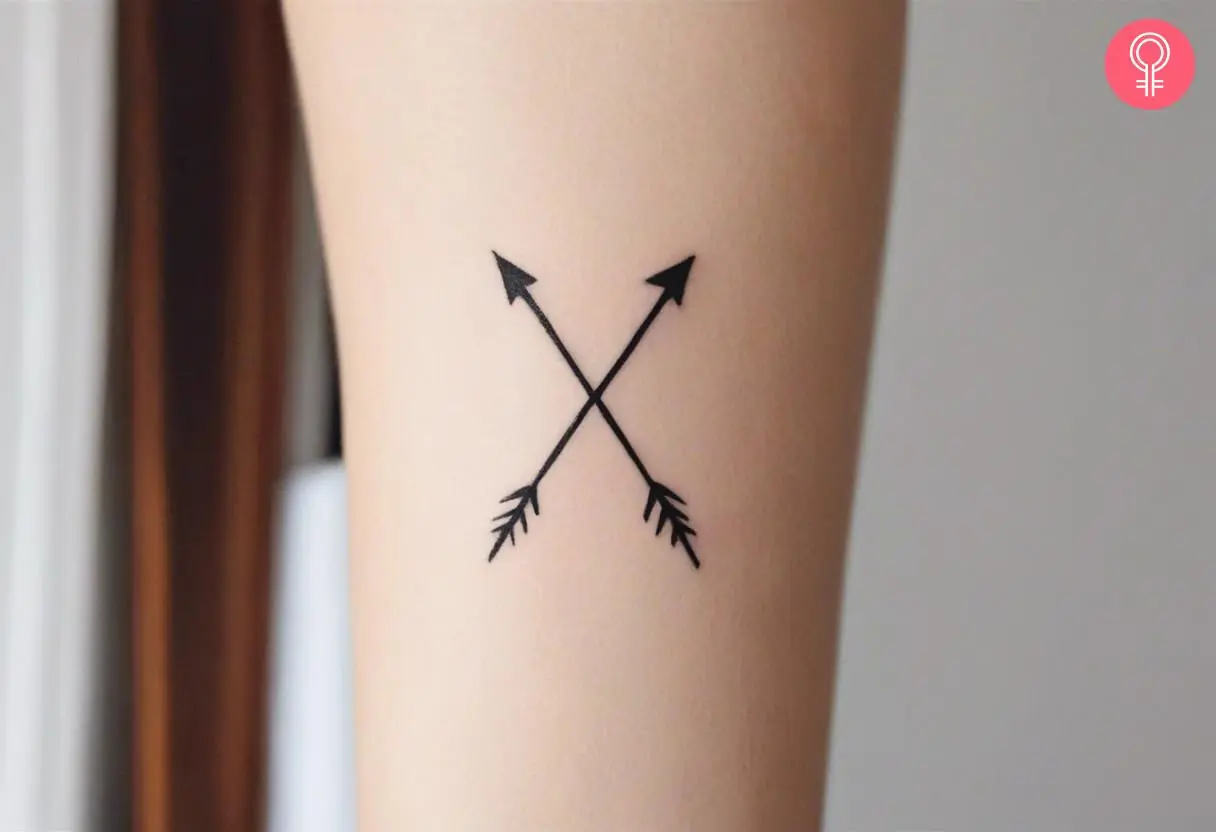  Woman with a X arrow tattoo on the forearm