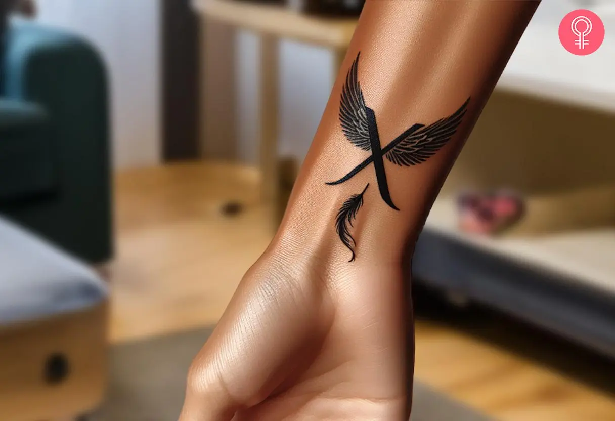 Woman with a X tattoo with wings on the wrist