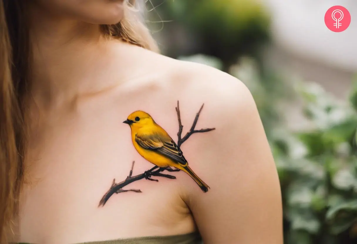 A woman with a vibrant yellow bird tattoo on her shoulder