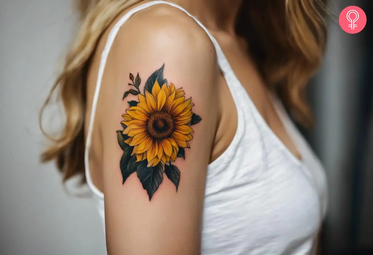 A woman with a yellow sunflower tattoo on her upper arm