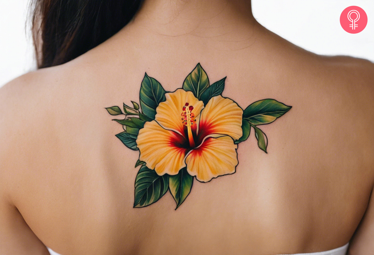 A yellow hibiscus tattoo on the back