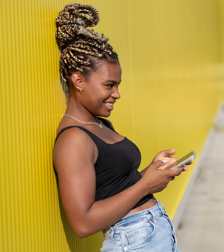 Side view of a woman with a braided weave updo hairstyle