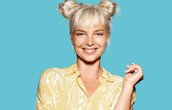 A blonde-haired woman sporting space buns with bangs