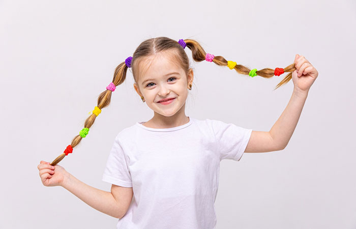 A little girl with colorful rubber bands hairstyle