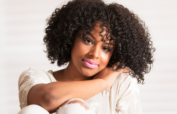 A woman flaunting curly hair with bangs