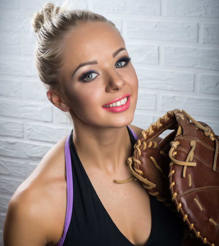 A woman softball player sporting a bun hairstyle