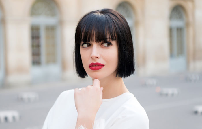 A woman sporting a short blunt bob hairstyle with bangs