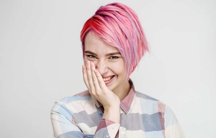 A woman with a lilac-hued, layered lob haircut