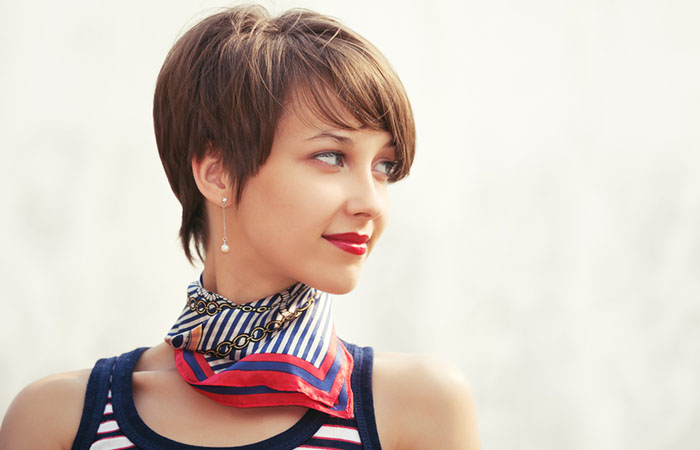 A woman with a long pixie cut with side-parted bangs