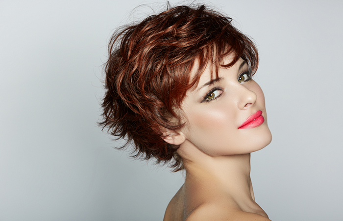 A woman with a mahogany, layered pixie cut