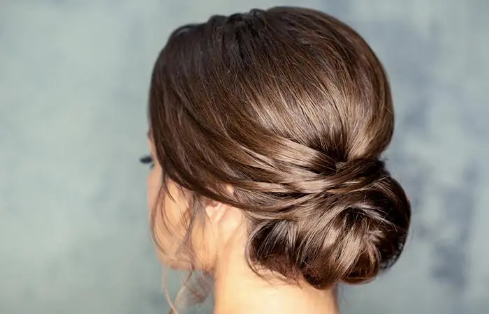 A woman with a simple low bun hairstyle