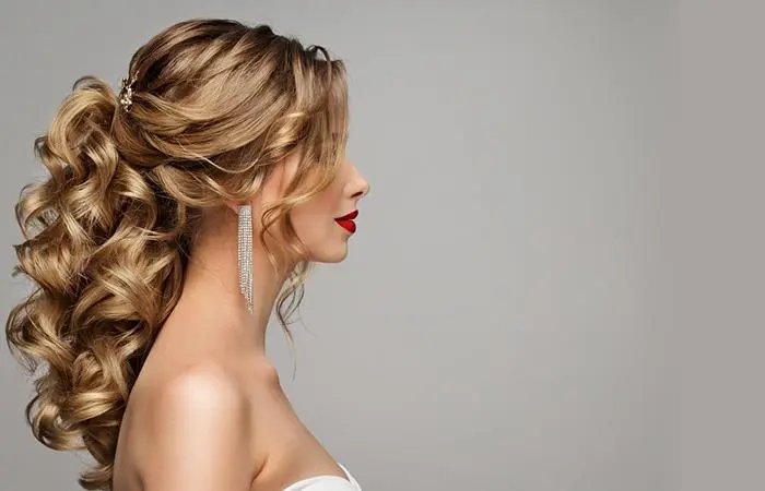 A woman with a sophisticated half-up bridesmaid hairstyle