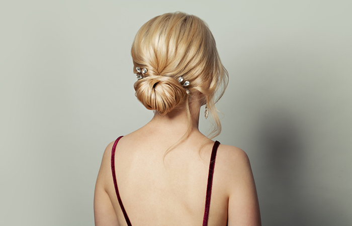 A woman with an elegant updo hairstyle and hair accessories