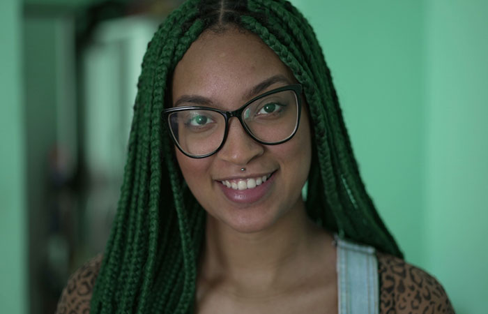 A woman with long green box braids hairstyle