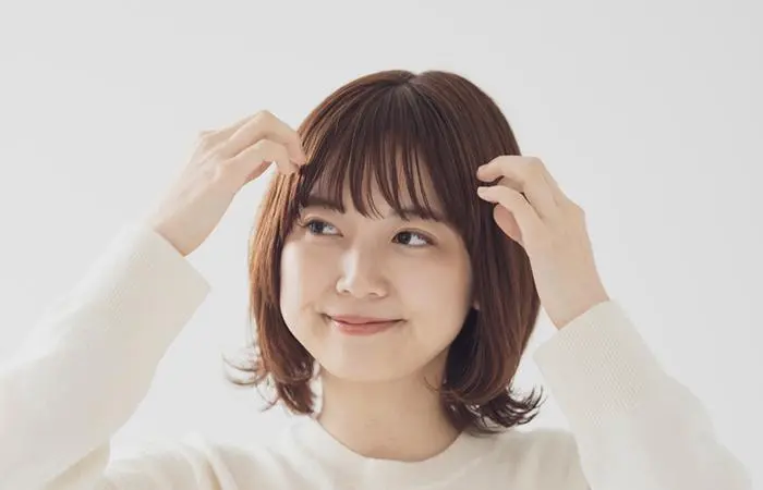 A woman with short hair and curtain bangs hairstyle