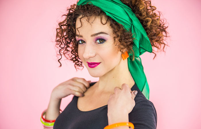 A woman with curly hair bandana hairstyle