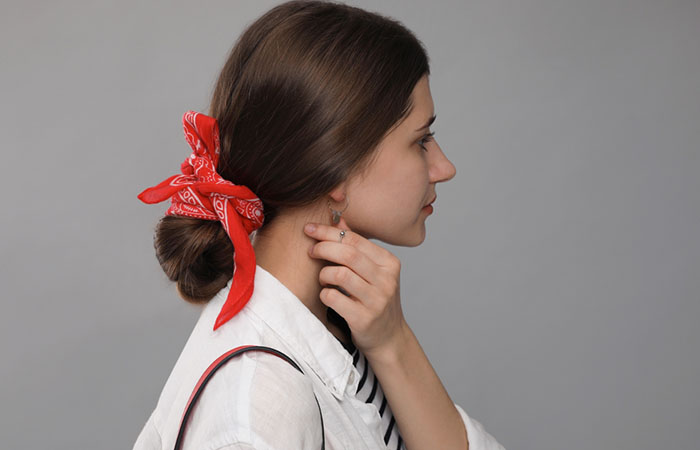 A woman with a bandana hairstyle with a bun