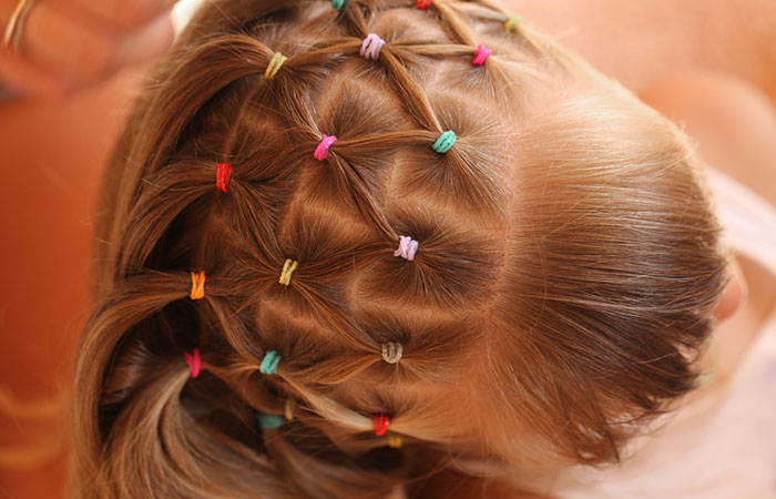 Close-up of a crisscross rubber band hairstyle