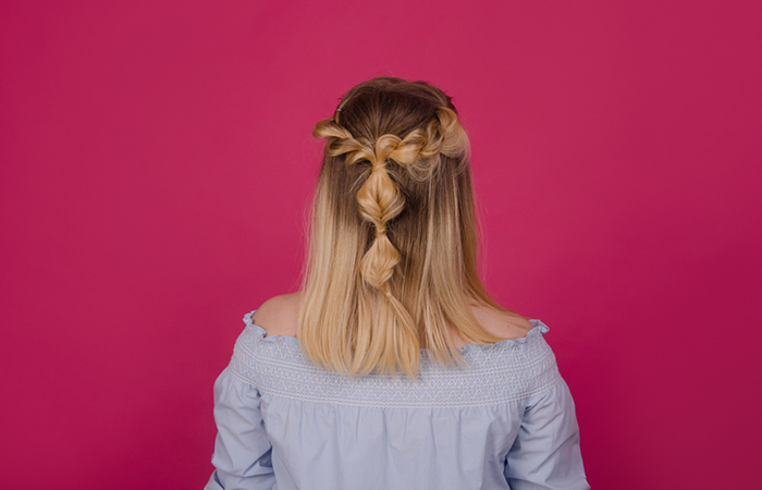 A woman with half up bubble braids