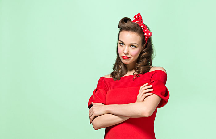 A woman with a 1940s side-swept hairstyle and loose curls