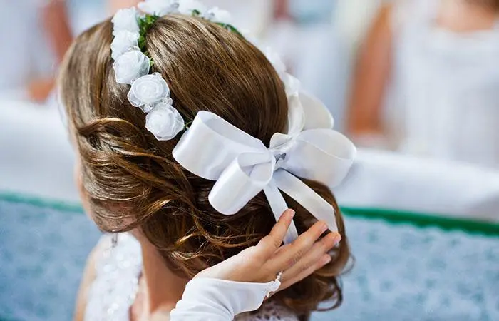 A kid with a flower girl updo hairstyle