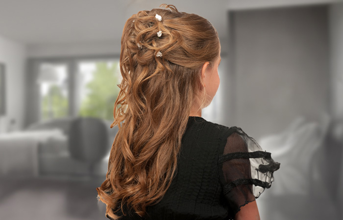 A kid with a half-up flower girl hairstyle