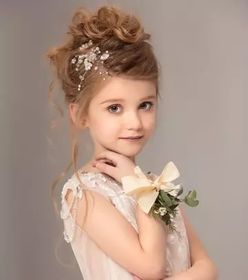 A kid with a flower girl hairstyle