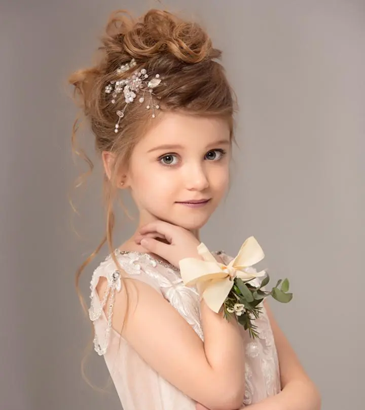 A kid with a flower girl hairstyle