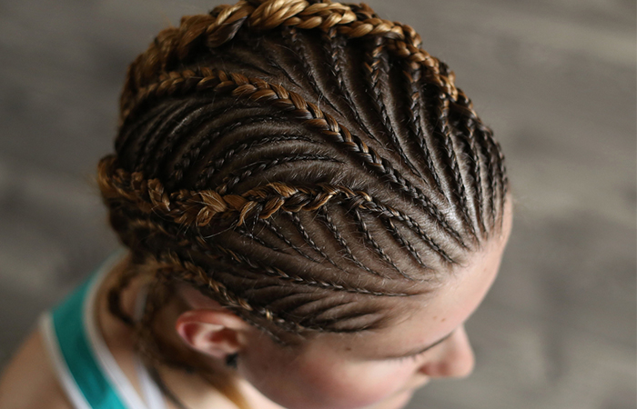 A close up shot of a braid hairstyle woven along the scalp