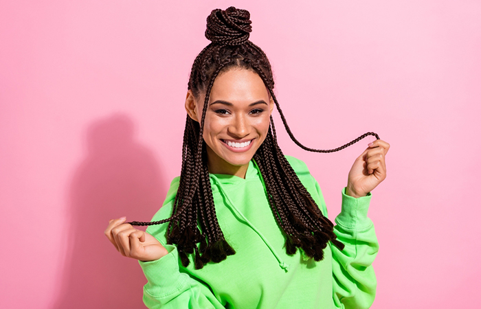 A woman with a weave protective braid hairstyle and laid edges