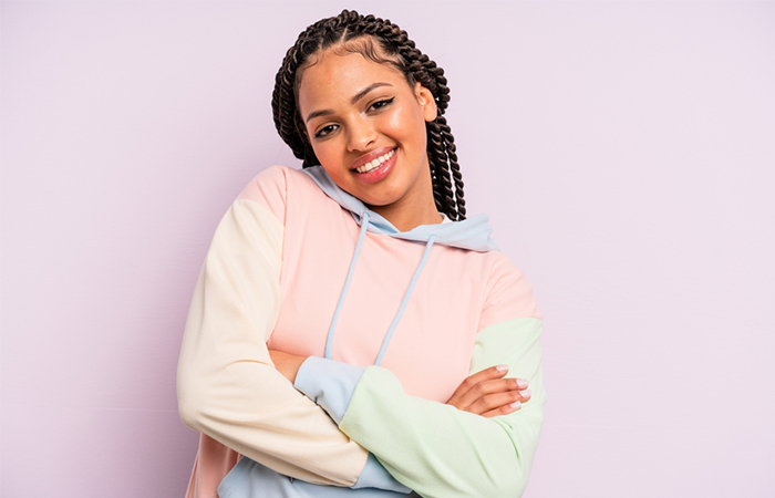 A woman sporting a woven twists half up half down hairstyle