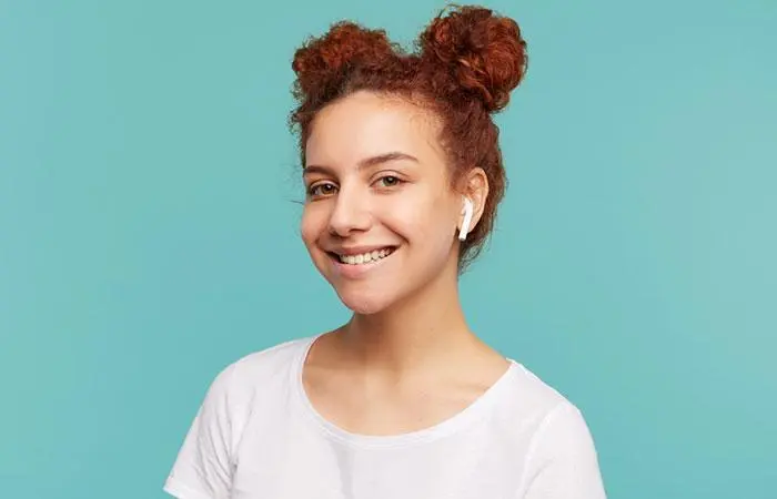 Woman with a curly hair double buns volleyball hairstyle