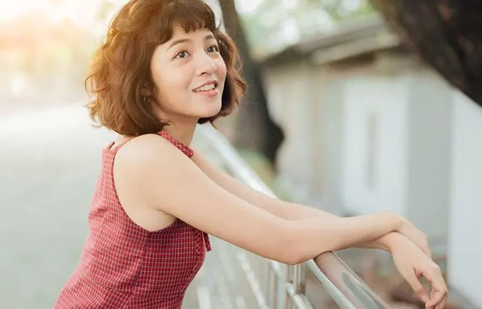 Woman with a modern pageboy haircut featuring a long bob with baby bangs