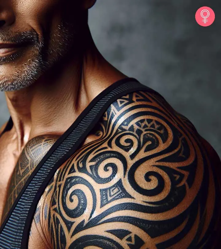 A man with an elaborate shoulder tribal tattoo design.