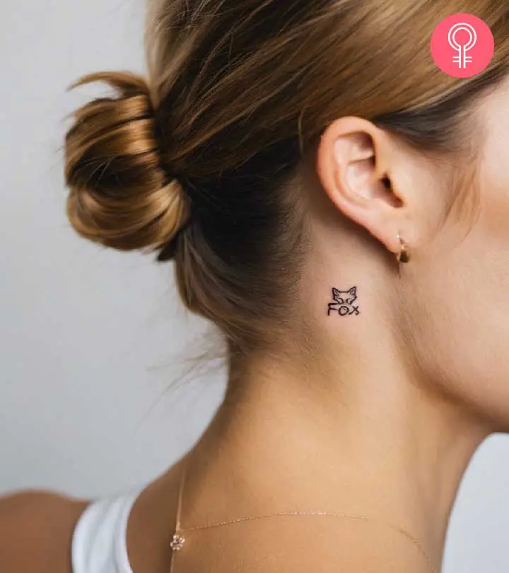 A miniature “Fox” last name tattoo with a fox face on top